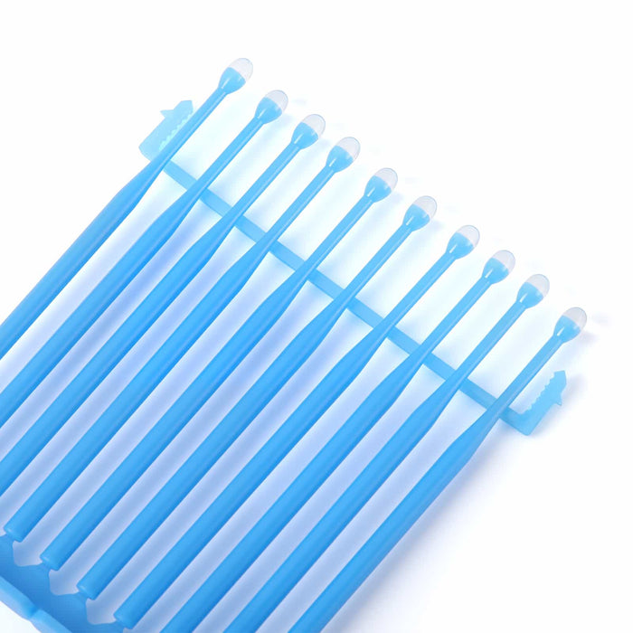 Blue dental adhesive tip applicators arranged on a base for easy access during restorative procedures - JMU DENTAL INC